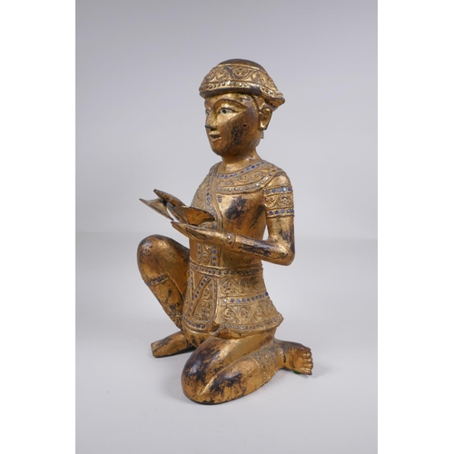 221 - A Tibetan carved gilt and painted wood figure of a musician with inset glass decoration, 38cm high, ... 