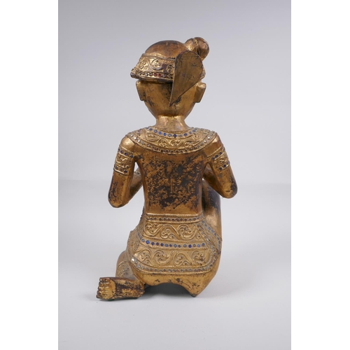 221 - A Tibetan carved gilt and painted wood figure of a musician with inset glass decoration, 38cm high, ... 