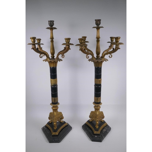 26 - A pair of Empire style bronze and ormolu Corinthian column four branch candelabra, 80cm high