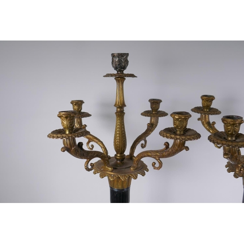 26 - A pair of Empire style bronze and ormolu Corinthian column four branch candelabra, 80cm high