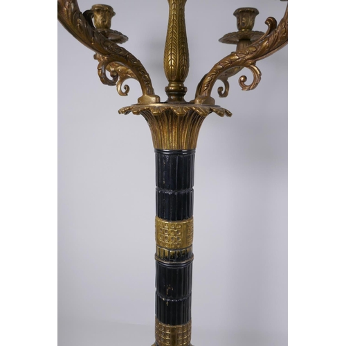 26 - A pair of Empire style bronze and ormolu Corinthian column four branch candelabra, 80cm high