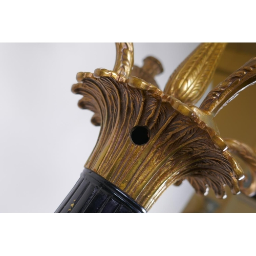 26 - A pair of Empire style bronze and ormolu Corinthian column four branch candelabra, 80cm high