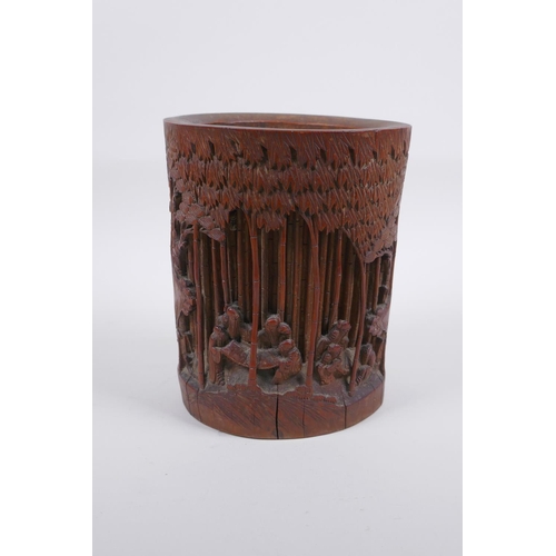 28 - A late C19th/early C20th Chinese carved bamboo brush pot decorated with scholars in a bamboo forest,... 