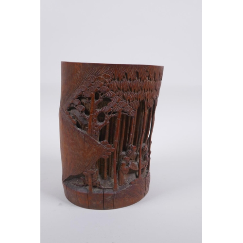 28 - A late C19th/early C20th Chinese carved bamboo brush pot decorated with scholars in a bamboo forest,... 