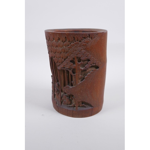 28 - A late C19th/early C20th Chinese carved bamboo brush pot decorated with scholars in a bamboo forest,... 