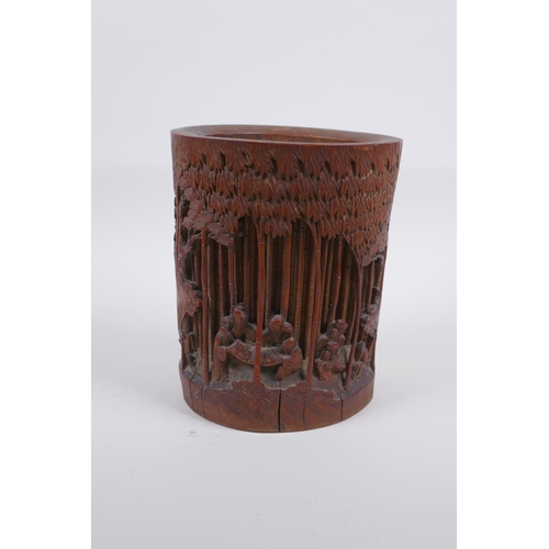 28 - A late C19th/early C20th Chinese carved bamboo brush pot decorated with scholars in a bamboo forest,... 