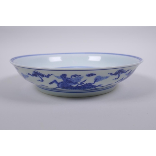 33 - A Chinese blue and white porcelain dish decorated with a kylin and the emblems of the eight immortal... 