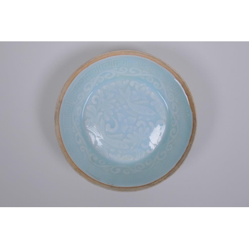 38 - A Chinese celadon glazed porcelain dish with underglaze carp decoration, 13cm diameter