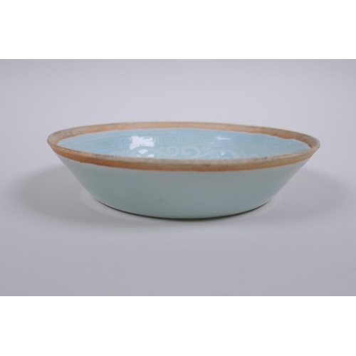 38 - A Chinese celadon glazed porcelain dish with underglaze carp decoration, 13cm diameter