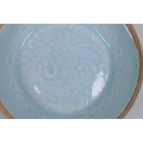 38 - A Chinese celadon glazed porcelain dish with underglaze carp decoration, 13cm diameter