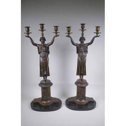 39 - A pair of Empire style bronze three branch figural candlesticks in the form of classical women, 74cm... 