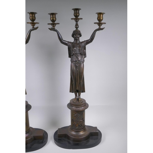 39 - A pair of Empire style bronze three branch figural candlesticks in the form of classical women, 74cm... 