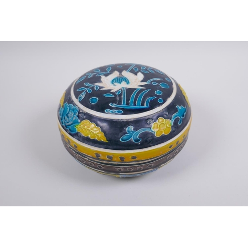 41 - A Chinese fahua porcelain box and cover with lotus flower decoration, 18cm diameter