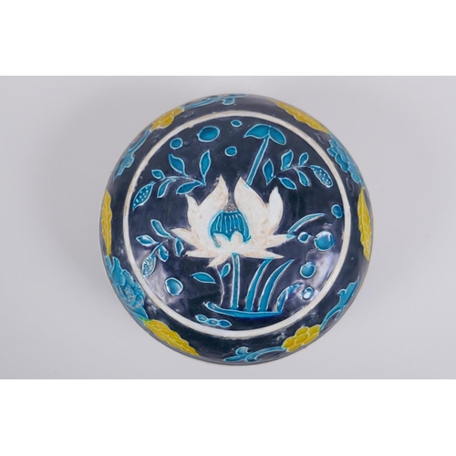 41 - A Chinese fahua porcelain box and cover with lotus flower decoration, 18cm diameter