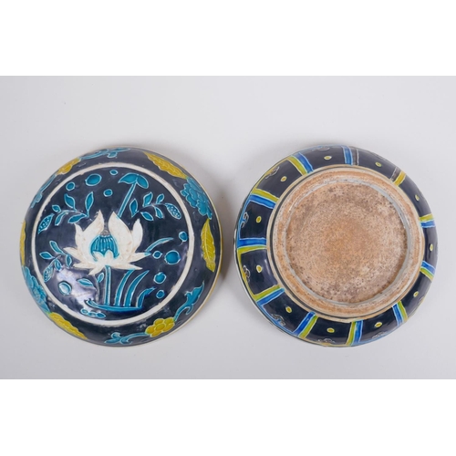 41 - A Chinese fahua porcelain box and cover with lotus flower decoration, 18cm diameter