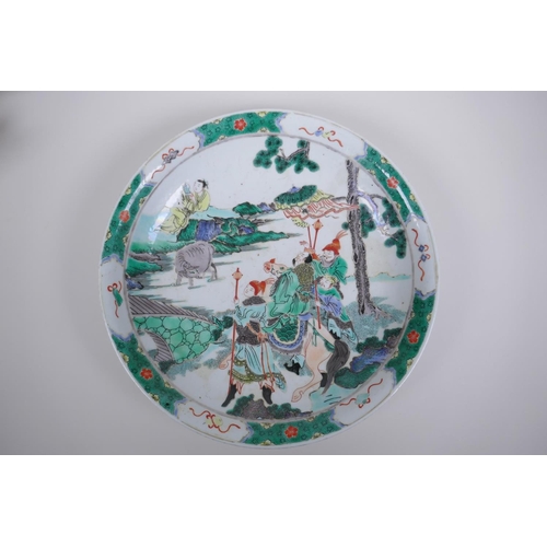 43 - A Chinese KangXi style famille verte porcelain charger decorated with figures in a landscape, 29cm d... 