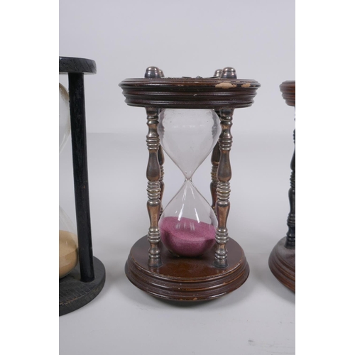 46 - A pair of vintage silver plated and turned wood hourglass sand timers with white metal decoration to... 