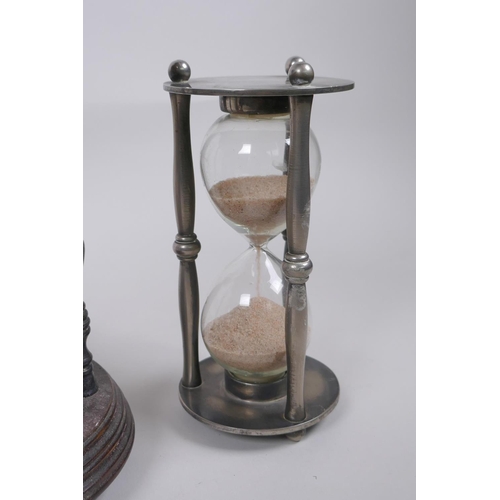 46 - A pair of vintage silver plated and turned wood hourglass sand timers with white metal decoration to... 