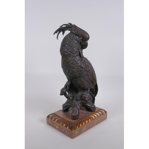 5 - A bronze figure of a cockatoo after Bergman, raised on a parcelgilt wood and marble base, 36cm high