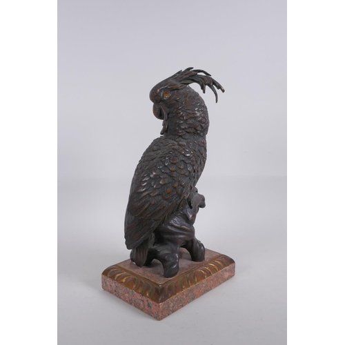 5 - A bronze figure of a cockatoo after Bergman, raised on a parcelgilt wood and marble base, 36cm high