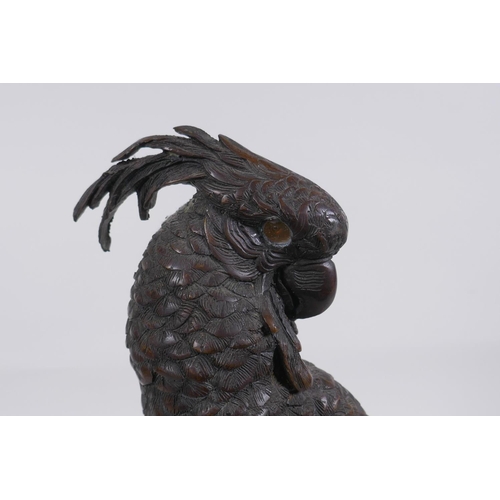 5 - A bronze figure of a cockatoo after Bergman, raised on a parcelgilt wood and marble base, 36cm high