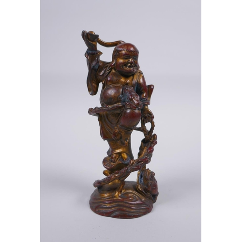 51 - A Chinese gilt and coppered bronze figure of Lohan, 16cm high