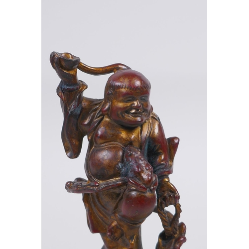 51 - A Chinese gilt and coppered bronze figure of Lohan, 16cm high