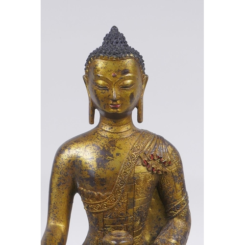 52 - A Sino Tibetan filled gilt bronze figure of Buddha, impressed double vajra mark to base, 30cm high