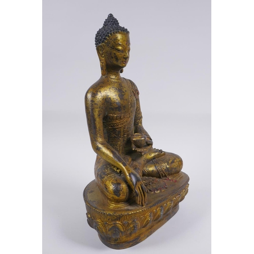 52 - A Sino Tibetan filled gilt bronze figure of Buddha, impressed double vajra mark to base, 30cm high