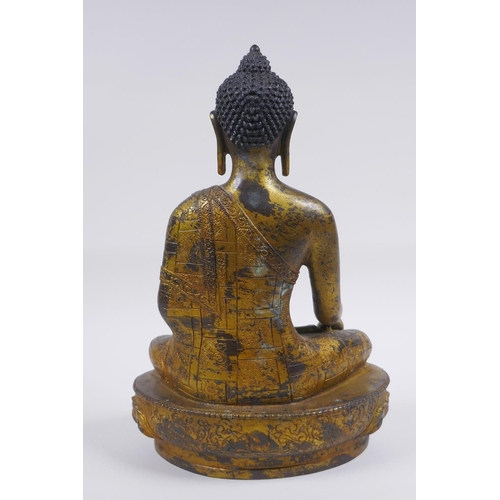 52 - A Sino Tibetan filled gilt bronze figure of Buddha, impressed double vajra mark to base, 30cm high