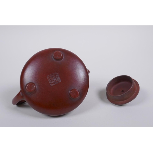 55 - A Chinese YiXing teapot with character inscription decoration, impressed seal mark to base, in a fit... 