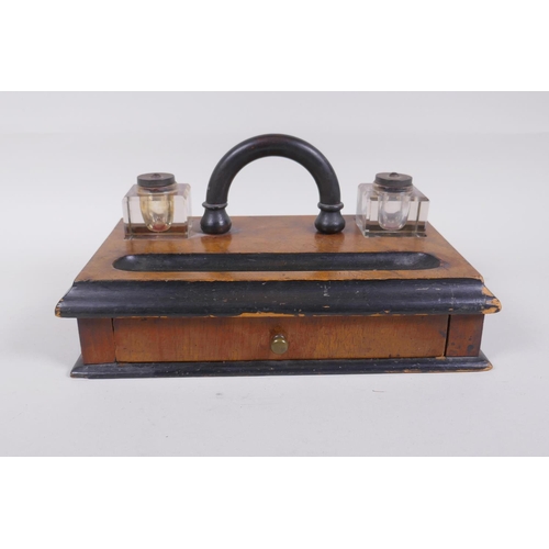 57 - An antique ebonised walnut desk set with twin glass ink wells and a single drawer, 28 x 16cm