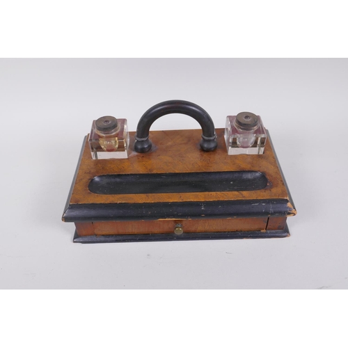 57 - An antique ebonised walnut desk set with twin glass ink wells and a single drawer, 28 x 16cm