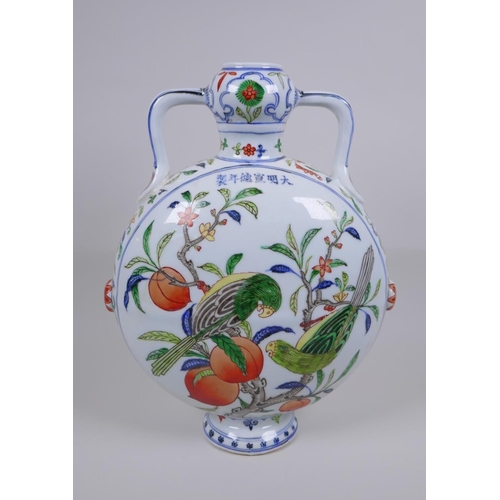 58 - A Chinese polychrome porcelain two handled moon flask decorated with parrots in a peach tree, Xuande... 