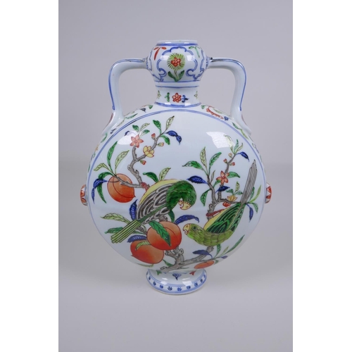 58 - A Chinese polychrome porcelain two handled moon flask decorated with parrots in a peach tree, Xuande... 