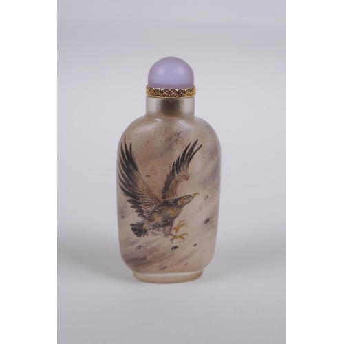 60 - A Chinese reverse decorated glass snuff bottle depicting eagles in flight, 9cm high