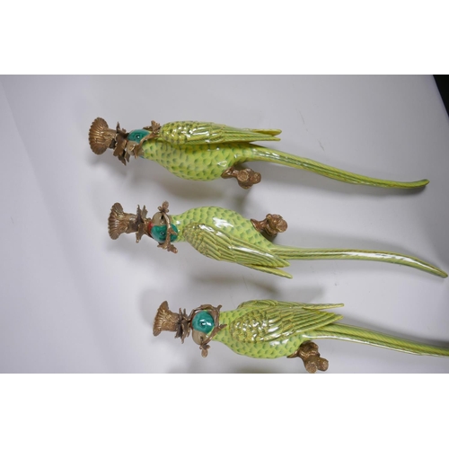 69 - Two pairs of polychrome porcelain and gilt metal parrot sconces, 47cm long