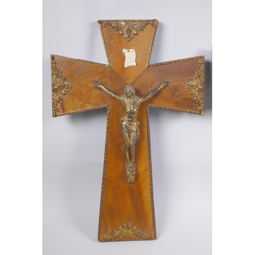 71 - A gilt bronze and wood crucifix with applied repousse brass mounts, and another wooden crucifix with... 