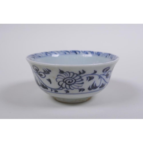 73 - A Chinese Ming style blue and white porcelain tea bowl and red and white porcelain saucer with shape... 