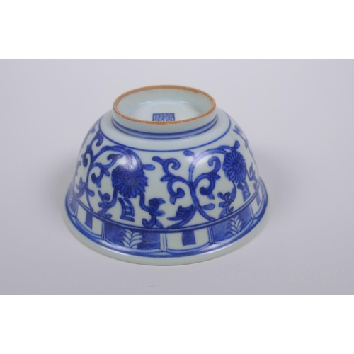 75 - A Chinese blue and white porcelain rice bowl with script and lotus flower decoration, 13cm diameter