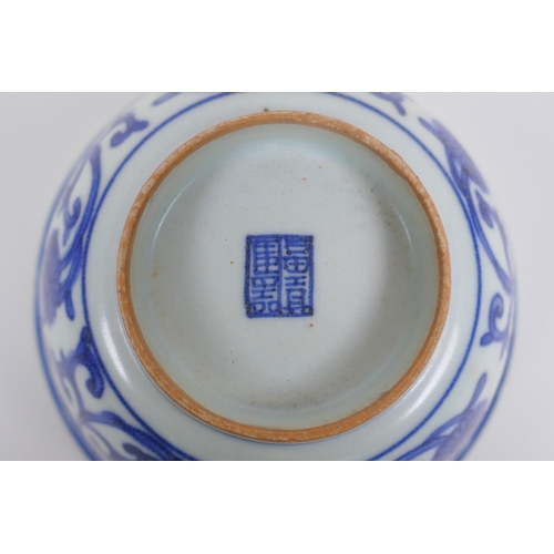 75 - A Chinese blue and white porcelain rice bowl with script and lotus flower decoration, 13cm diameter