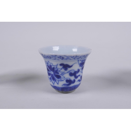 79 - A Chinese blue and white porcelain cylinder pot, a miniature porcelain tea bowl, and a miniature por... 