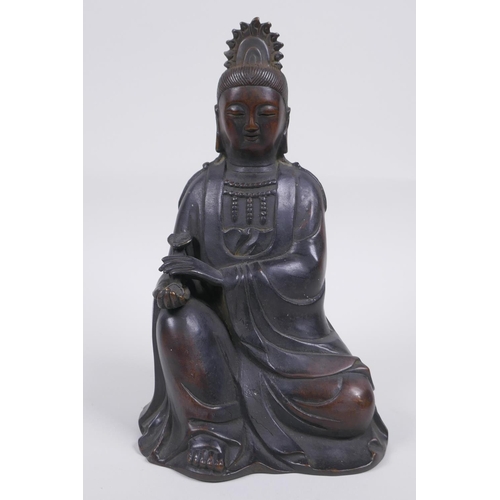 80 - A Chinese bronze figure of Quan Yin seated and holding a ruyi, 23cm high