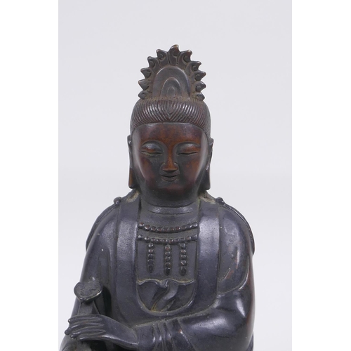 80 - A Chinese bronze figure of Quan Yin seated and holding a ruyi, 23cm high