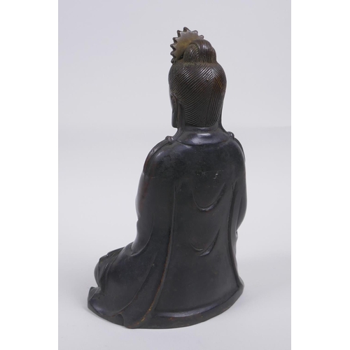 80 - A Chinese bronze figure of Quan Yin seated and holding a ruyi, 23cm high