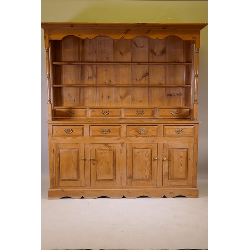 1120 - A pine dresser, the upper section with delft rack over four drawers, open sides, the base with four ... 