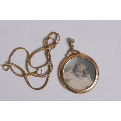 654 - A yellow metal circular locket, marks rubbed, probably 9ct, 7.7g, on a 14ct gold plated chain, 4cm d... 