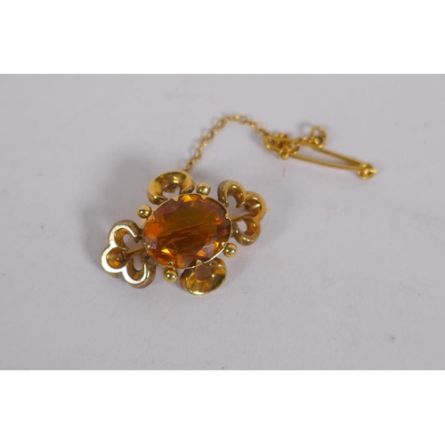 657 - A Victorian yellow metal pendant brooch, set with a citrine, 3cm long, 3.8g