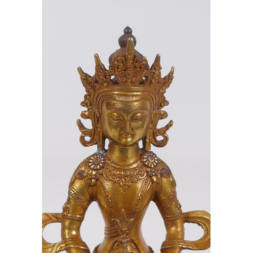 320 - A Sino Tibetan gilt bronze Buddha seated holding a stupa, impressed double vajra mark to base, 28cm ... 