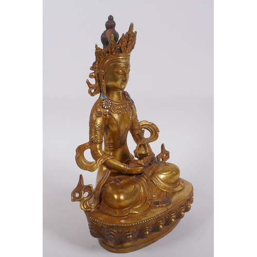 320 - A Sino Tibetan gilt bronze Buddha seated holding a stupa, impressed double vajra mark to base, 28cm ... 